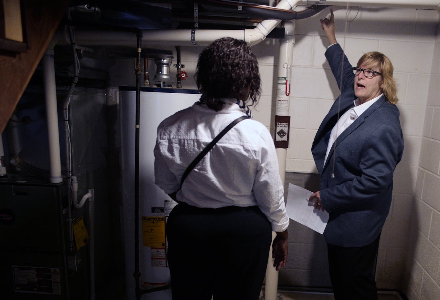 Realtor Kath Hammerseng shows Latisha Lowe the merits of a starter home in Crystal listed in the 170,000's . This would be Lowe's first home. ]Richard Tsong-Taatarii &#xef; richard.tsong-taatarii@startribune.com