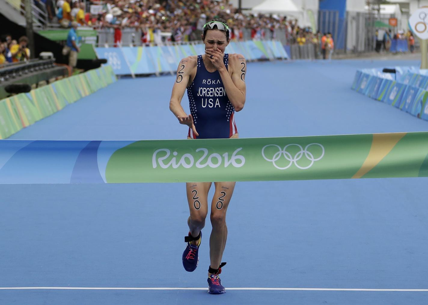 Gwen Jorgensen of the United States wins the women's triathlon competition of the 2016 Summer Olympics in Rio de Janeiro, Brazil, Saturday, Aug. 20, 2016. (AP Photo/Gregory Bull)