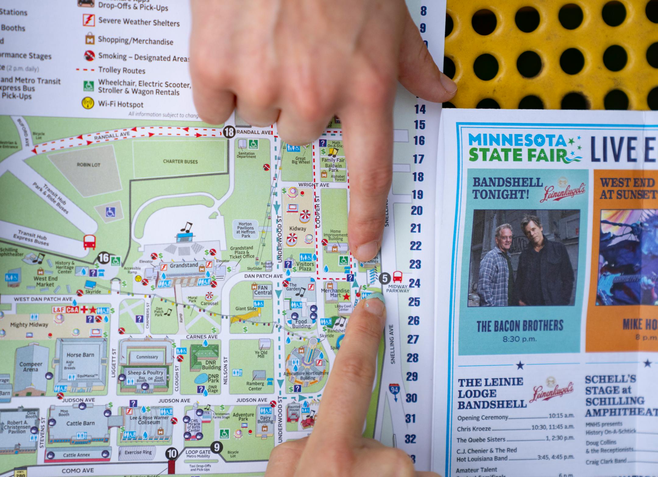 Nadine Hackshaw and her sister, Renée Mueggenborg, top to bottom, plan for their day with a map at the State Fairgrounds in Falcon Heights.