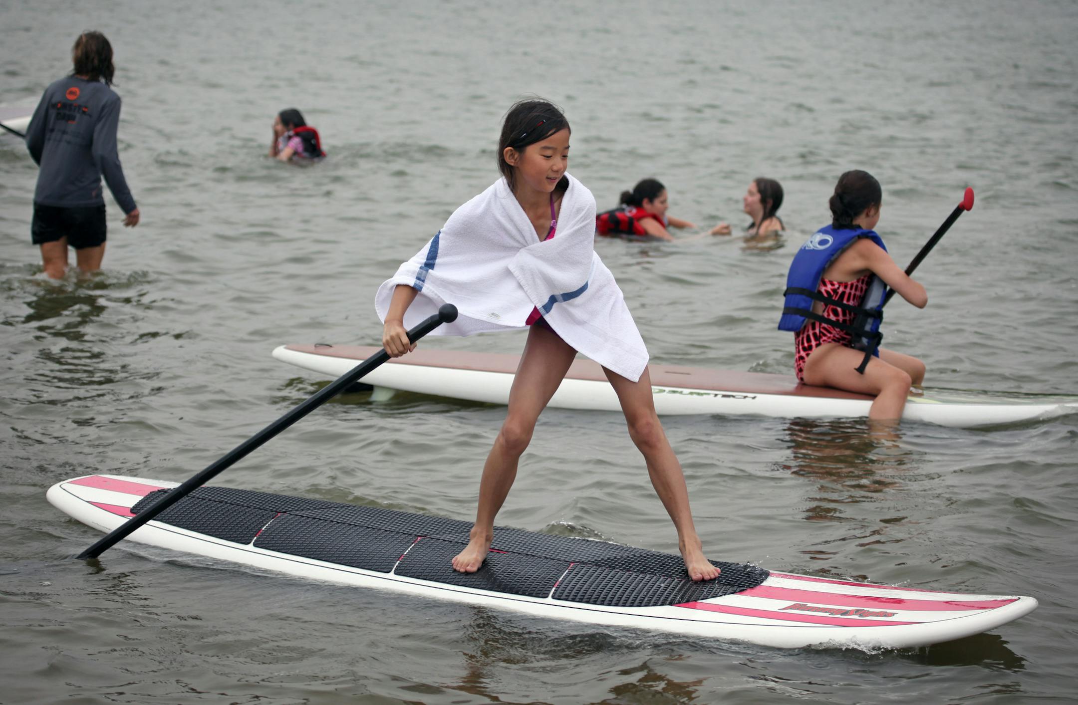 Olivia Overend, 11, perfects her technique on a paddleboard while trying out the new sport on Lake Nokomis Thursday morning. ] Children from Shriner's hospital who have limb deficiencies are using stand-up paddleboards for a form of fun therapy. CQ all names. BRIAN PETERSON ‚Ä¢ brianp@startribune.com Minneapolis, MN 07/14/2011bestmn2012 bestmn2012