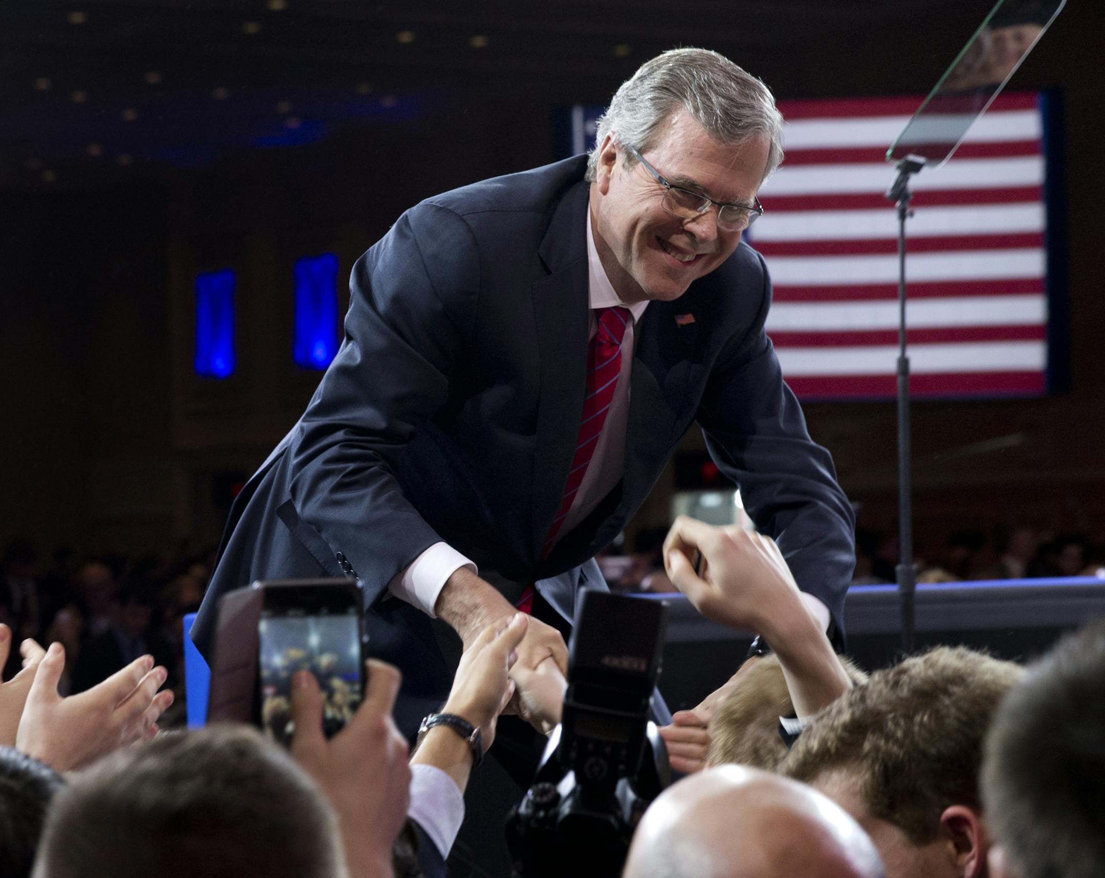 Former Florida Gov. Jeb Bush shakes hands with people in the audience after speaking at the Conservative Political Action Conference (CPAC) in National Harbor, Md., Friday, Feb. 27, 2015. (AP Photo/Carolyn Kaster)