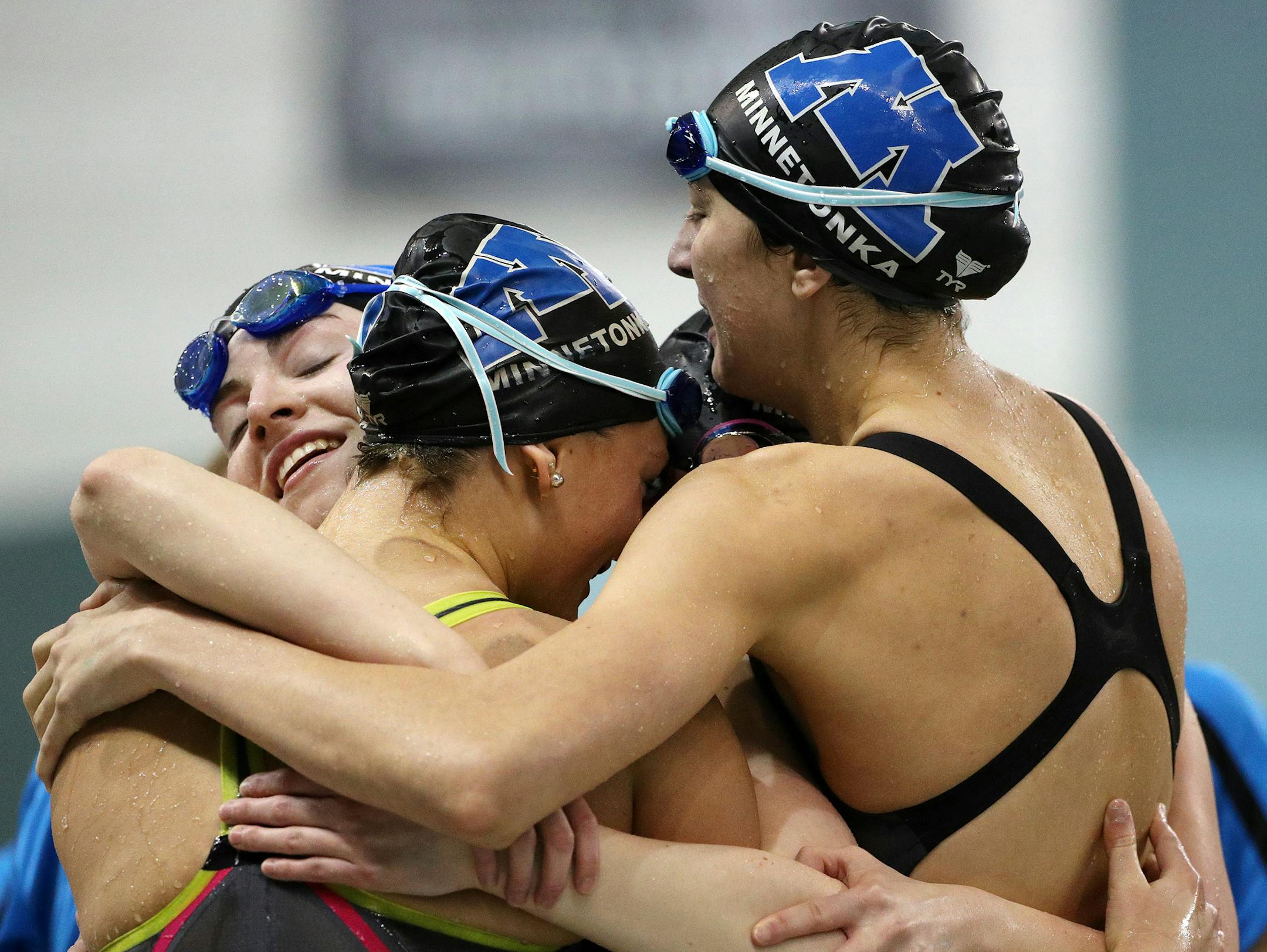 Minnetonka swimmers hugged after winning the 200 freestyle relay at the state meet a year ago. Two relay members return.