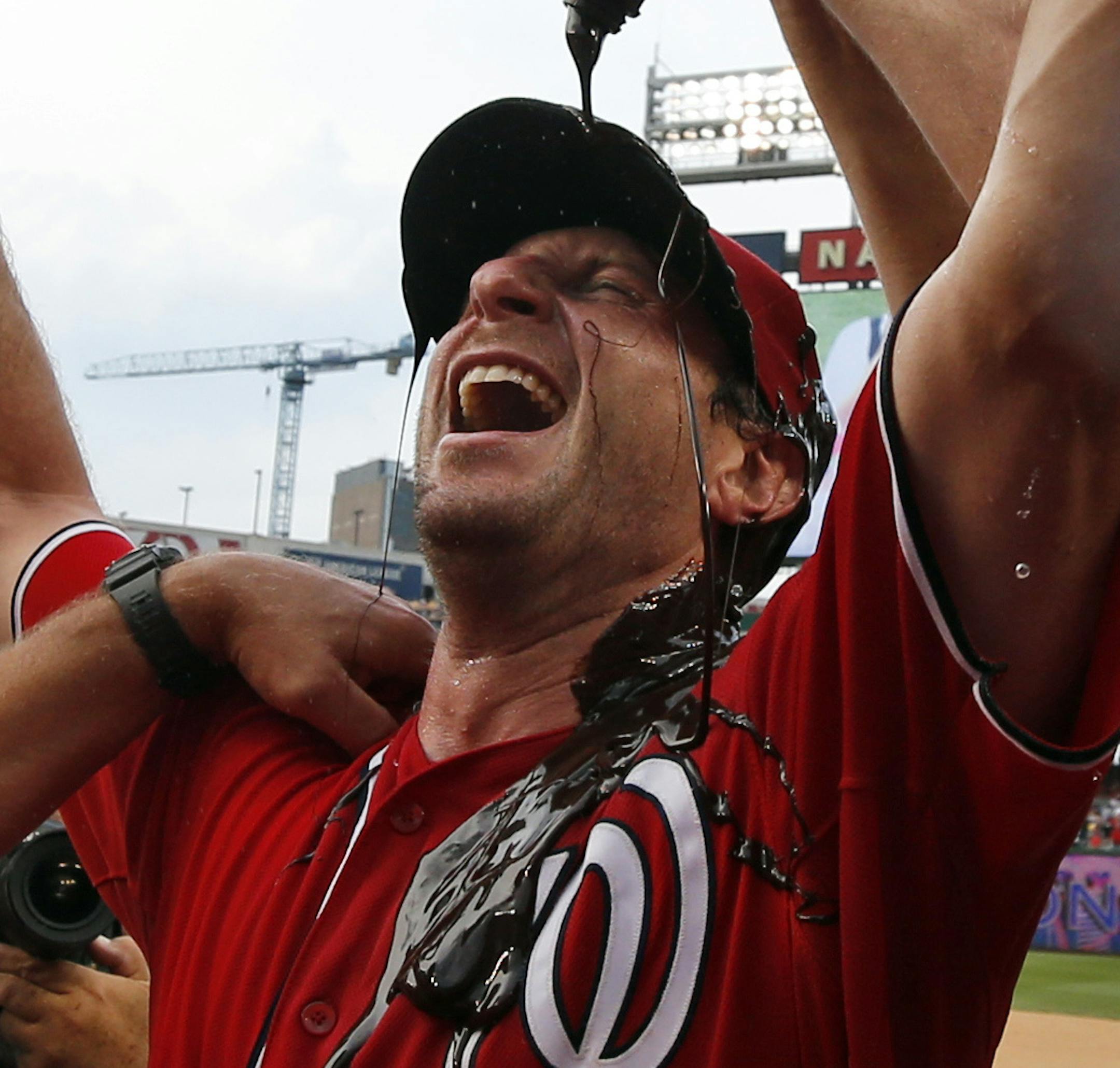 Washington Nationals' Jordan Zimmermann, right, douses starting pitcher Max Scherzer, center, with chocolate syrup as Scherzer celebrates with pitching coach Steve McCatty, left, after Scherzer's no-hitter baseball game against the Pittsburgh Pirates at Nationals Park, Saturday, June 20, 2015, in Washington. The Nationals won 6-0. (AP Photo/Alex Brandon) ORG XMIT: NAT118 ORG XMIT: MIN1506201807110005