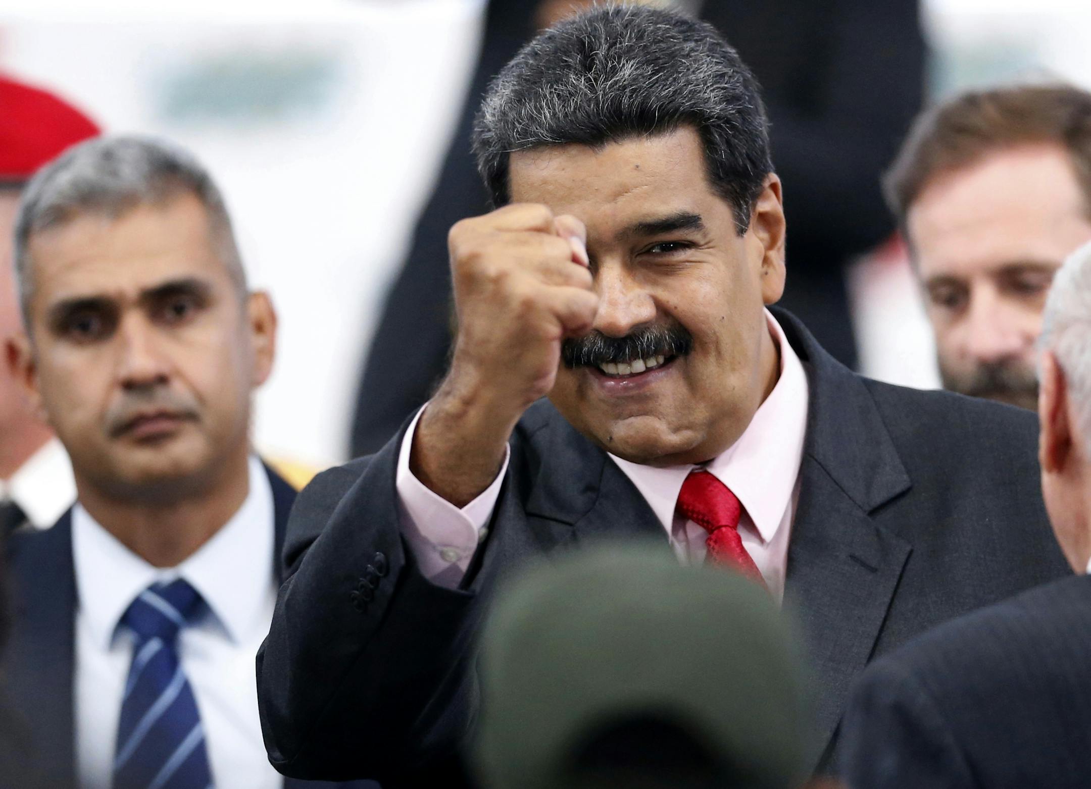 Venezuela's President Nicolas Maduro greets guests after receiving from the National Electoral Council, CNE, a certificate declaring him the winner of the presidential election, during a ceremony at CNE headquarters in Caracas, Venezuela, Tuesday, May 22, 2018. (AP Photo/Ariana Cubillos)