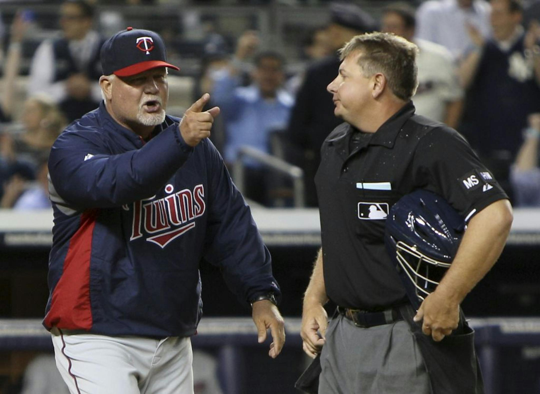 Minnesota Twins manager Ron Gardenhire, left, continues to yell at umpire Greg Gibson after Gardenhire was thrown out of the baseball game against the New York Yankees during the third inning at Yankee Stadium in New York, Tuesday, April 17, 2012.