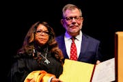 Prince's sister, Tyka Nelson, left, stands with then-University of Minnesota President Eric Kaler, when he presented an honorary degree posthumously t