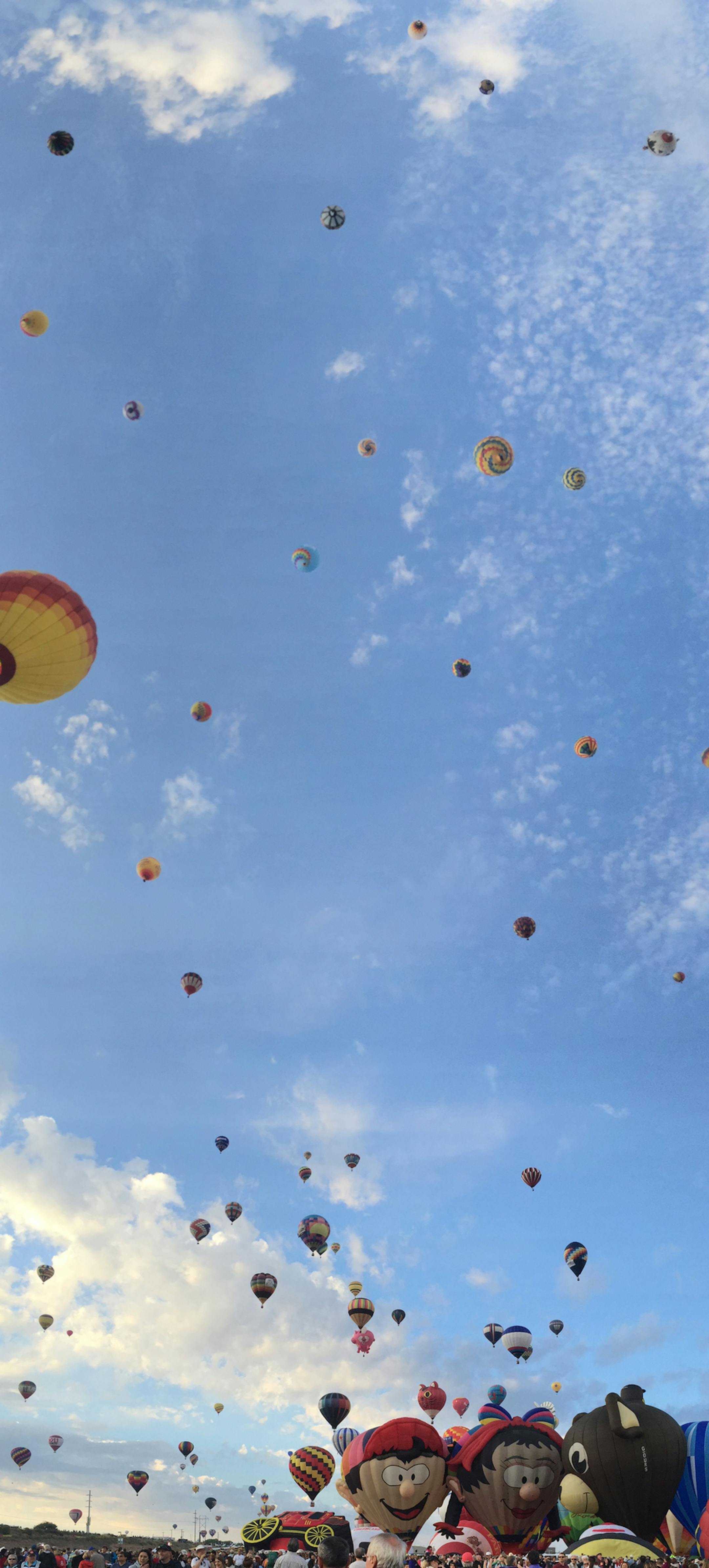 About 550 balloons hover in the sky Saturday, October 3, 2015 during a mass asencion at the Albuqurque International Balloon Fiesta. Balloonists from all over the world travel to New Mexico for the 10-day event.
