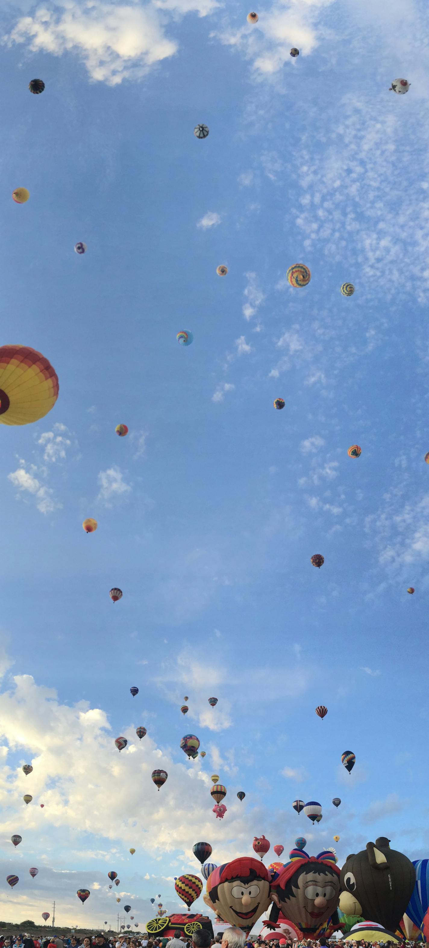 About 550 balloons hover in the sky Saturday, October 3, 2015 during a mass asencion at the Albuqurque International Balloon Fiesta. Balloonists from all over the world travel to New Mexico for the 10-day event.