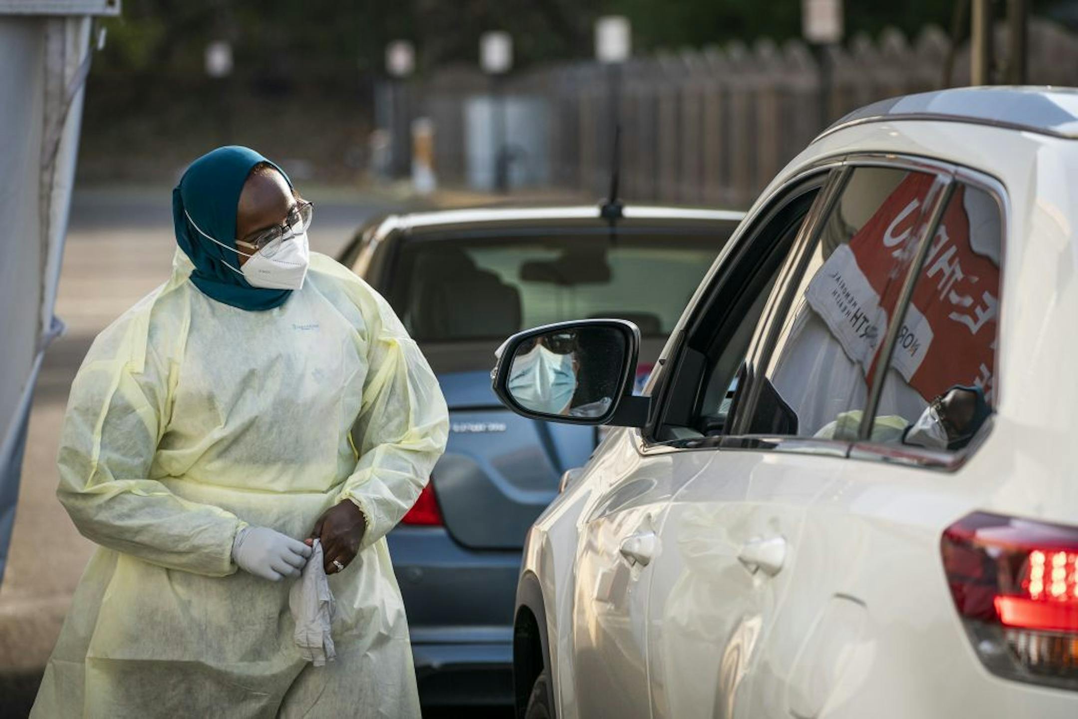 Medical assistant Samara Yusuf tested a patient in the drive-through COVID-19 testing site at North Memorial Health in Robbinsdale.