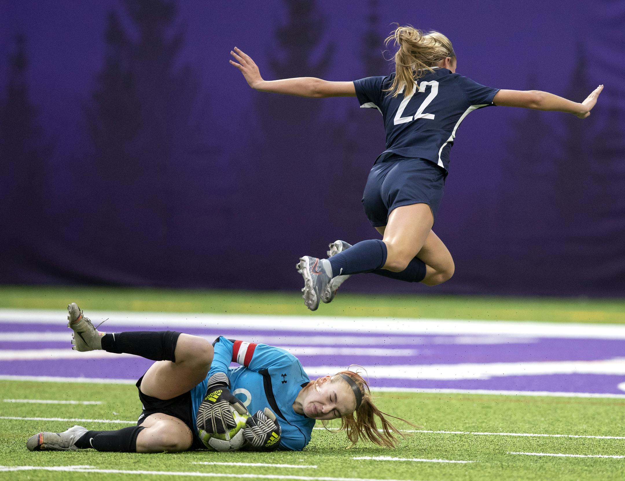 Orono goal keeper Clare Gagne made a save in the first half as Anna Wagner of Mahtomedi jumped over her .] Jerry Holt • Jerry.holt@startribune.com Class 1A girls championship between Mahotmedi and Orono at U.S. Bank Stadium Thursday Oct. 31, 2019. in Minneapolis, MN. Jerry Holt
