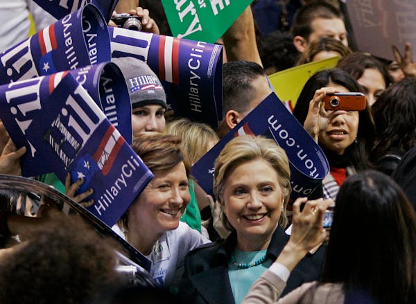 Democratic presidential hopeful, Sen. Hillary Rodham Clinton, D-N.Y., poses for pictures at a campaign rally in Los Angeles Saturday, Feb. 2, 2008.