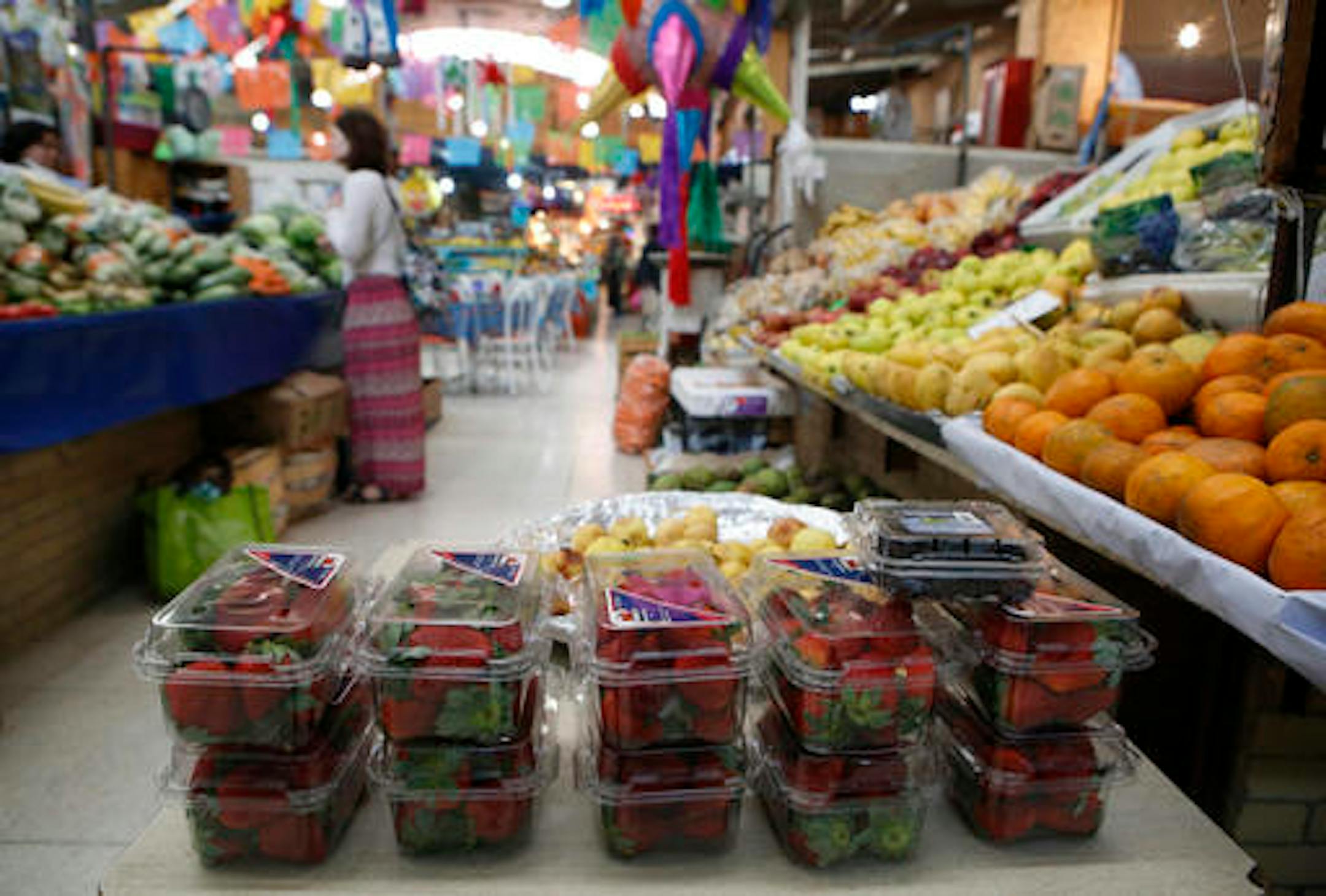 Packaged strawberries are displayed for sale at the stand of a fruit and vegetable seller in Mercado Medellin, in Mexico City, Thursday, Feb. 2, 2017. Mexico is the world's leading exporter of refrigerators and flat-screen TVs. Cars and trucks such as the Ram 1500 crew cab, Ford Fiesta and Chevrolet Trax fill U.S. dealer lots. Mexican berries, vegetables and beef born south of the border abound at American supermarkets. (AP Photo/Rebecca Blackwell)