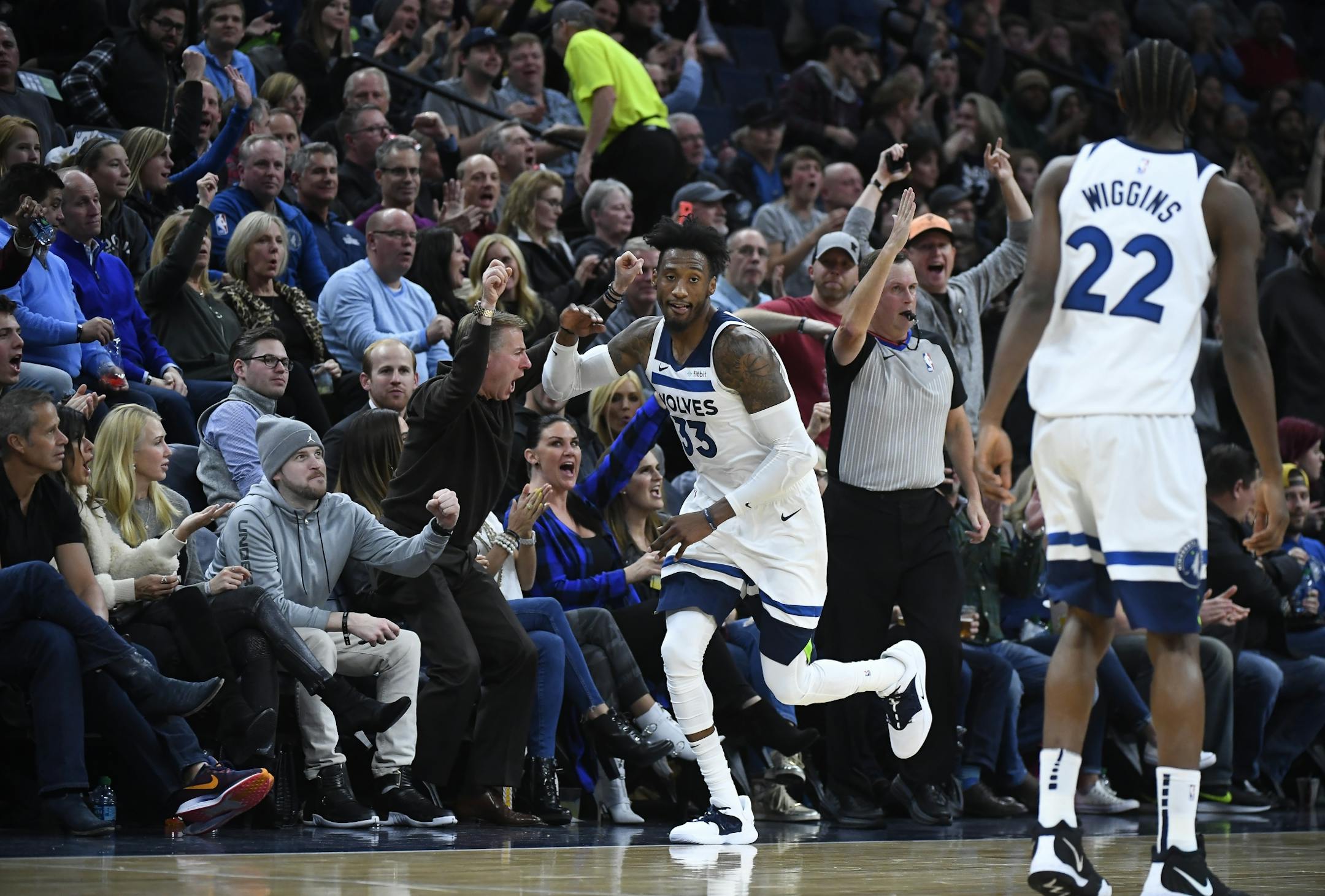 Minnesota Timberwolves forward Robert Covington (33) high fived fans after hitting a 3-pointer in the second half against the New Orleans Pelicans.
