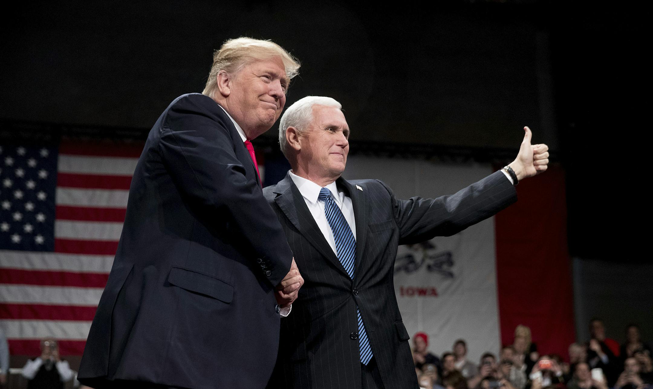 President-elect Donald Trump takes the stage after being introduced by Vice President-elect Mike Pence, right, at a rally at Hy-Vee Hall, Thursday, Dec. 8, 2016, in Des Moines. (AP Photo/Andrew Harnik) ORG XMIT: MIN2016121212192634