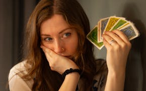 Elena Smith holds her cards close while playing a board game last month at Bad Weather Brewery in St. Paul.