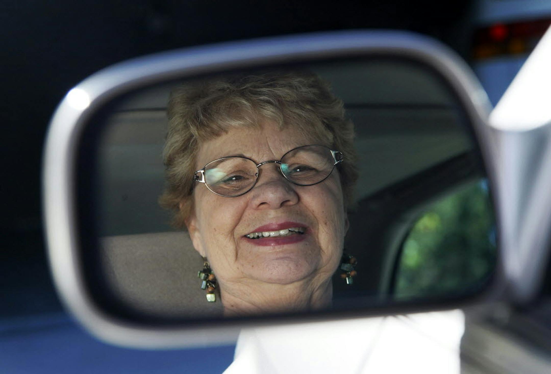 Sandy Wiseman is reflected in the rearview mirror, in Schaumburg, Ill. Wiseman and her husband, Jerry, took refresher driving classes to help them stay safe behind the wheel for many more years.