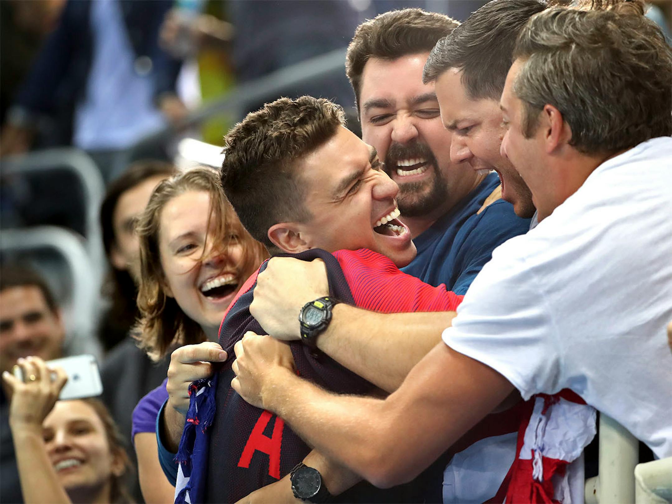 USA�s Anthony Irvin climbes into the crowd into a gaggle of friends to celebrate his gold medal in the 50 freestyle.
