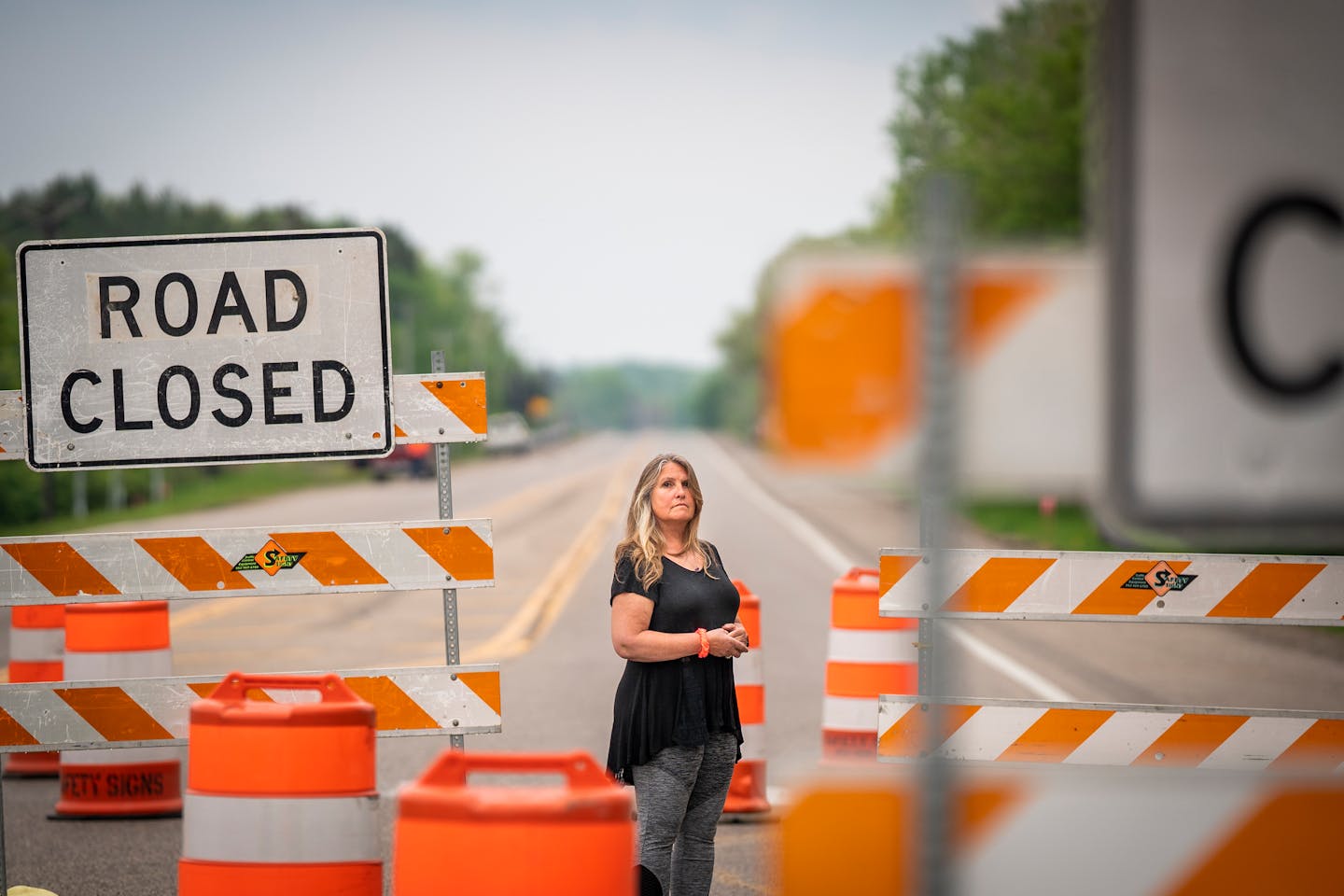 Tina Langhans, who lost her daughter in a head on crash on Highway 12 in 2015, posed for a portrait in front of the road construction signs at the corner of Highway 12 and Baker Park Road in Maple Plain. ] LEILA NAVIDI • leila.navidi@startribune.com