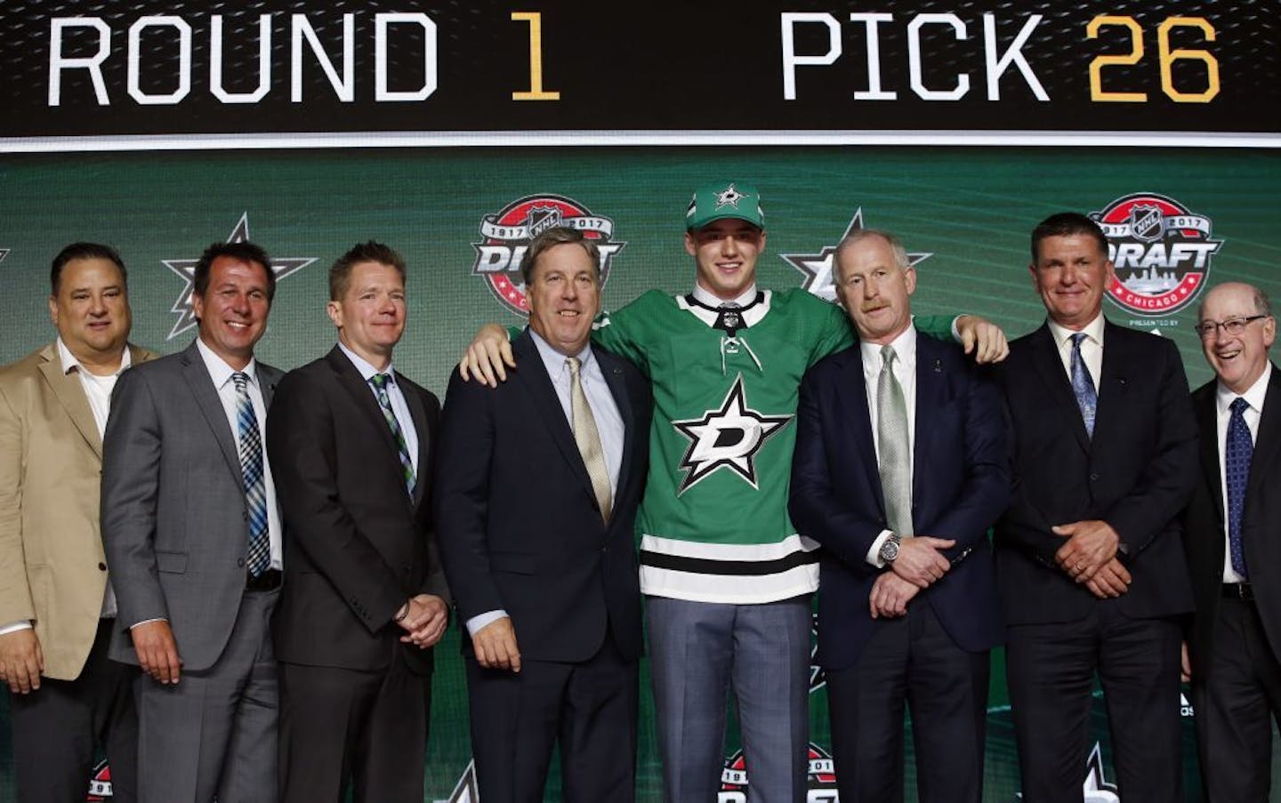 Jake Oettinger of Lakeville, center, wears a Dallas Stars jersey after being selected by the team during the first round of the NHL hockey draft, Friday, June 23, 2017, in Chicago.