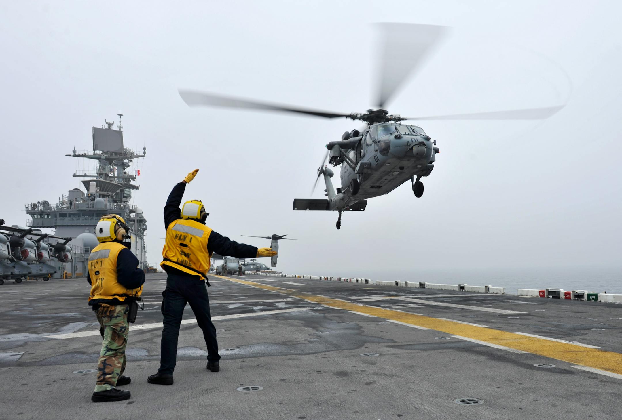 In this photo provided by the U.S. Navy, a Sea Hawk helicopter takes off from the flight deck of the amphibious assault ship USS Bonhomme Richard to assist in search and rescue operations on Friday, April 18, 2014 after the South Korean ferry, the Sewol, flipped onto its side in the East China Sea. Rescuers are still searching for over 200 people still missing and feared dead. (AP Photo.U.S. Navy, Mass Communication Specialist 2nd Class Michael Achterling)
