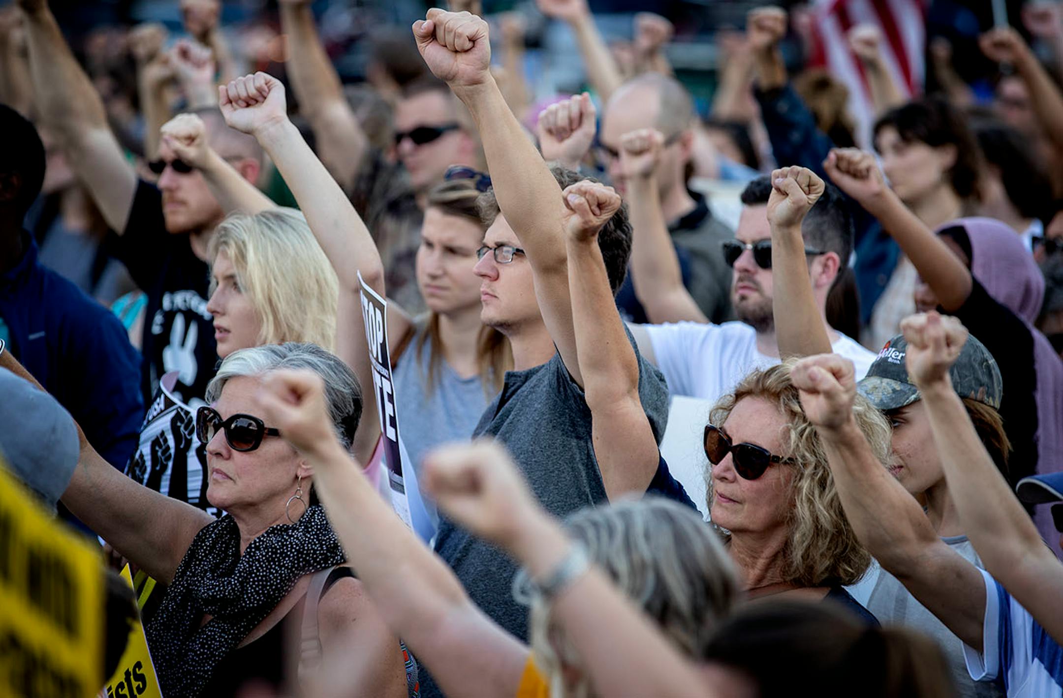 Demonstrators raised a fist during the Solidarity with anti-racists in Charlottesville march that began in front of the Minneapolis Republican Party office on Franklin Avenue on Monday.