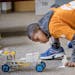 Matthewos Michael, 10, cq, took a closer look at his team's remote car during a competition at the STEM camp at Earle Brown Elementary school, Friday,