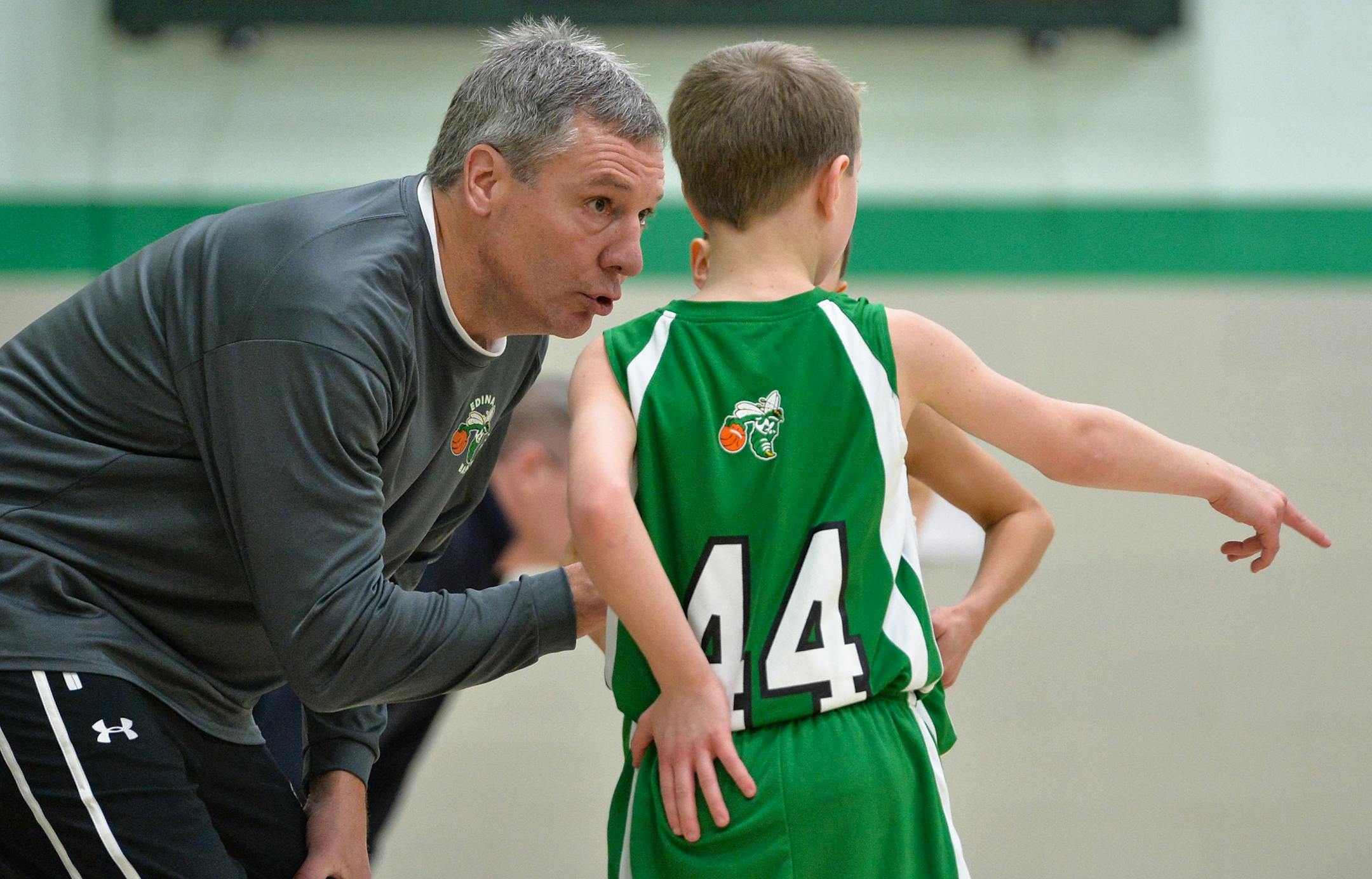 Head coach, Paul Schmidt, talks with three of his players during a lull in play during a recent tournament game.