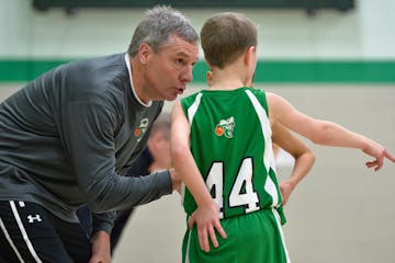 Head coach, Paul Schmidt, talks with three of his players during a lull in play during a recent tournament game.