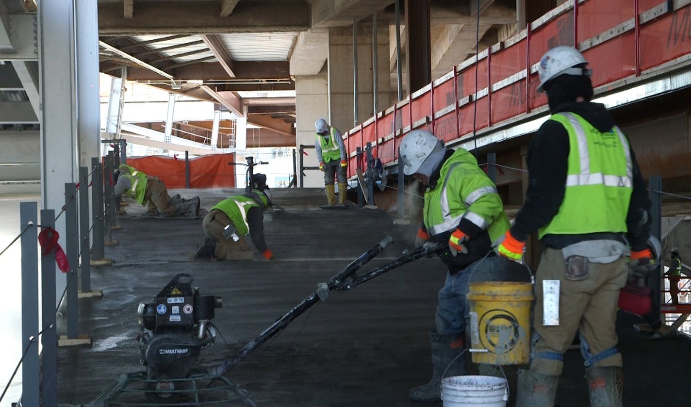 The Viking stadium workforce is kept a little bit warmer with Heaters and several workers that spent their shifts trying to keep the heaters all working. Cement finishers.