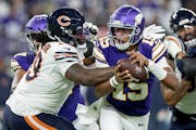 Minnesota Vikings quarterback Joshua Dobbs (15) slips away from Gervon Dexter Sr. of the Chicago Bears in the second quarter Monday, November 27, 2023