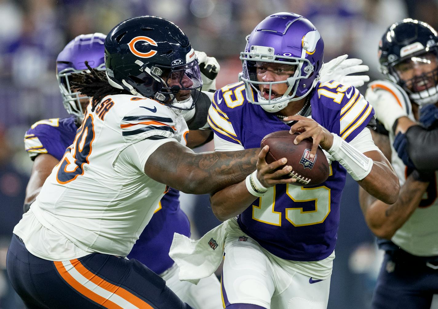 Minnesota Vikings quarterback Joshua Dobbs (15) slips away from Gervon Dexter Sr. of the Chicago Bears in the second quarter Monday, November 27, 2023, at U.S. Bank Stadium in Minneapolis, Minn. ] CARLOS GONZALEZ • carlos.gonzalez@startribune.com