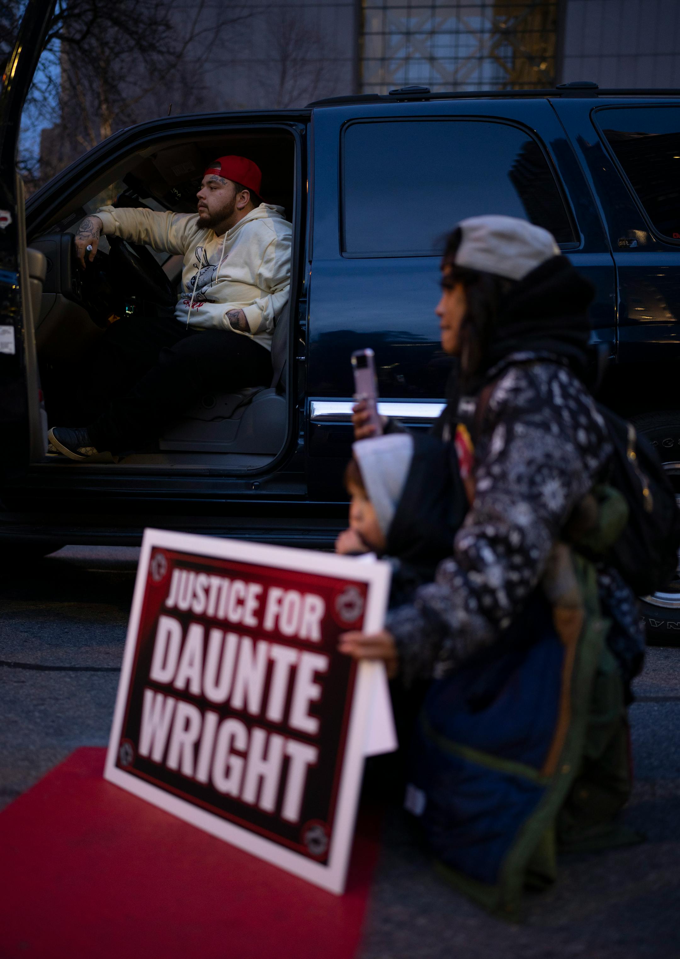 Daunte Wright's brother, Damik, listened to speakers at a rally outside the Hennepin County Government Center, where the trial of former police officer Kimberly Potter began Tuesday evening, Nov. 30, 2021 in Minneapolis. A demonstration of support for the family of Daunte Wright by 75 or so people took place Tuesday, Nov. 30, 2021 outside the Hennepin County Government Center followed by a short march in Minneapolis. ] JEFF WHEELER • Jeff.Wheeler@startribune.com
