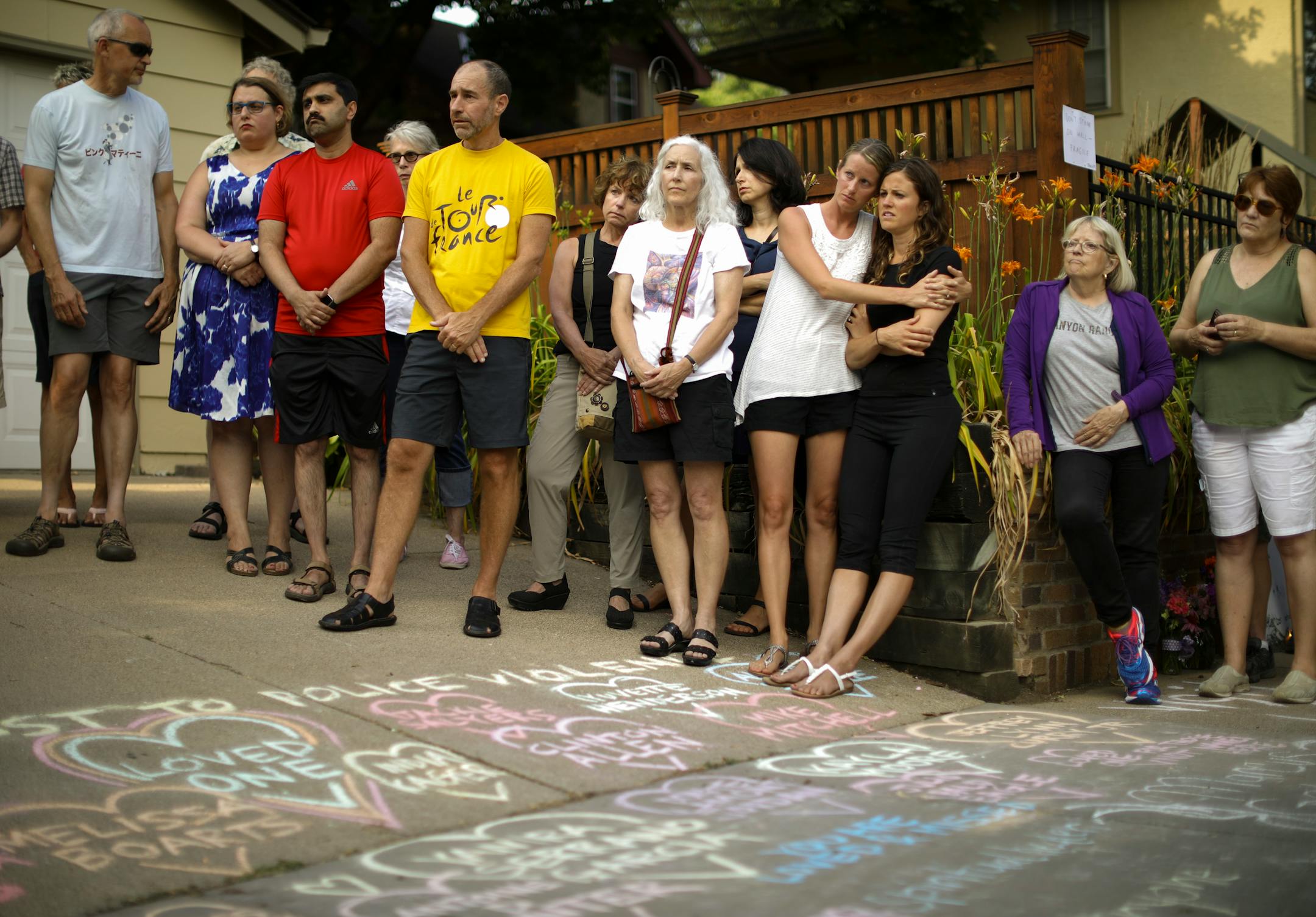 People listened as Bethany Bradley of Women's March Minnesota spoke at the beginning of a vigil to remember Justine Damond Sunday evening.