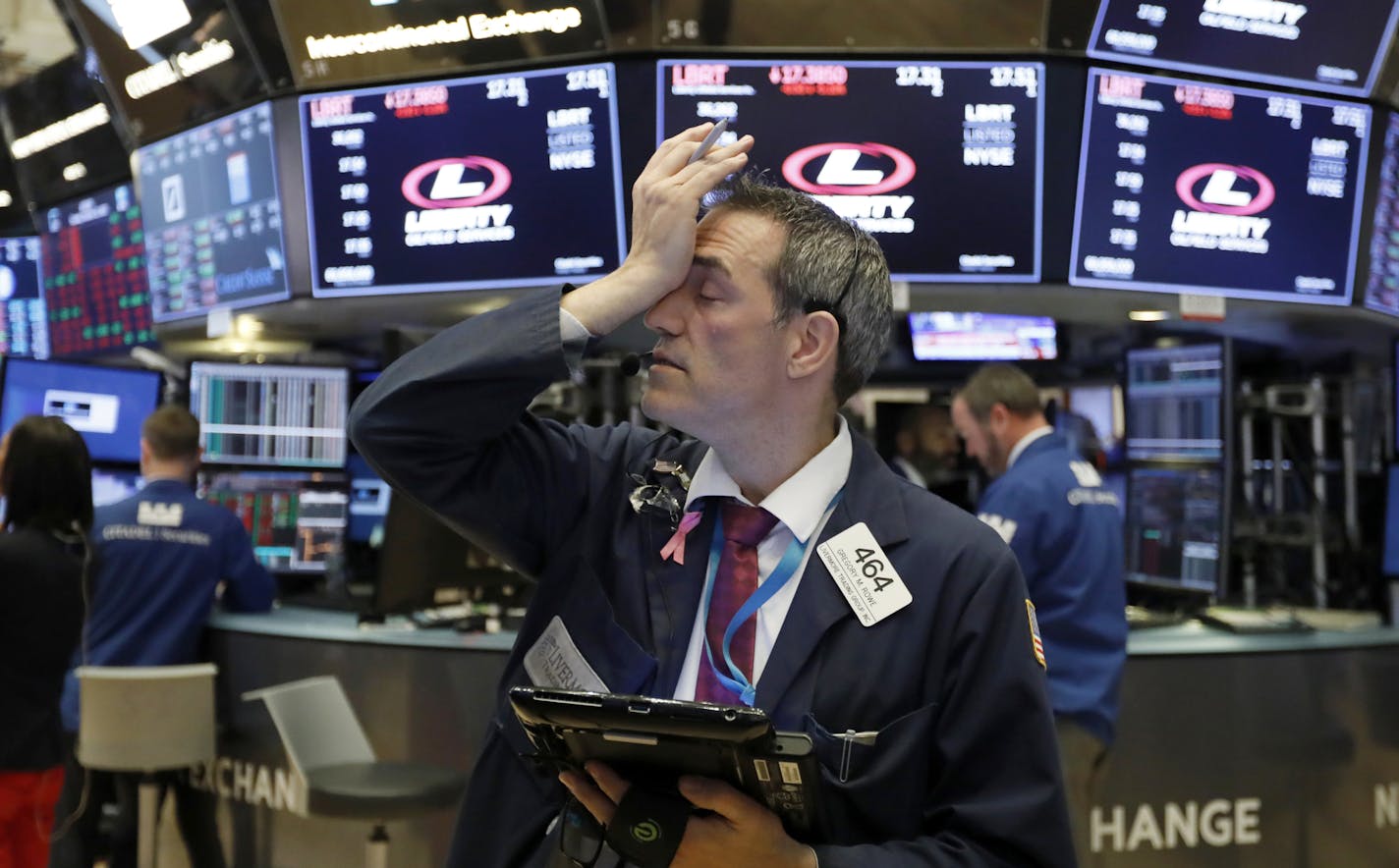 Trader Gregory Rowe works on the floor of the New York Stock Exchange, Tuesday, Oct. 23, 2018. Stocks are opening sharply lower on Wall Street following big drops in Asia and Europe. (AP Photo/Richard Drew)