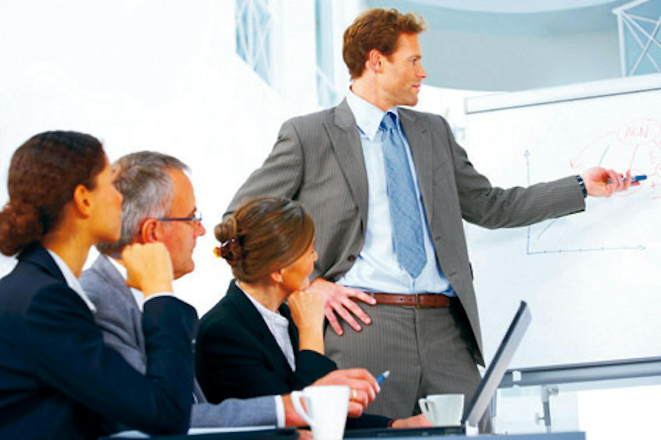 Young speaker at a business meeting giving a presentation.