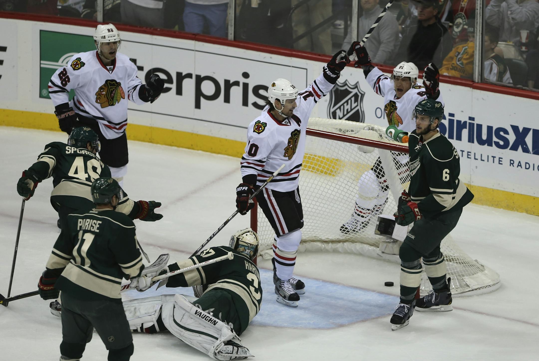 Patrick Sharp celebrated with teammate Marian Hossa as the Blackhawks scored in the first period against the Wild on Tuesday night.
