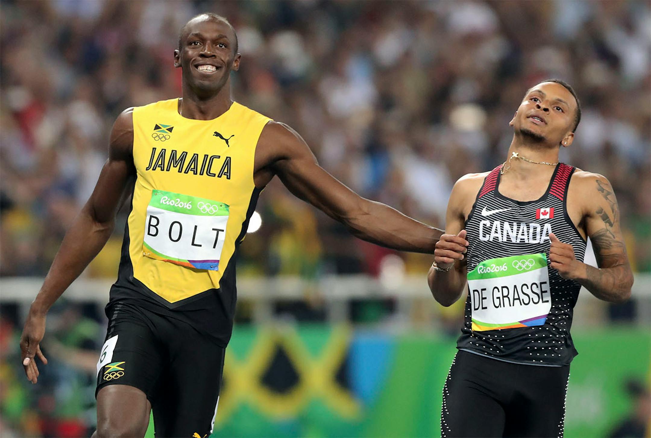 Jamaica's Usain Bolt and Canada's Andre De Grasse compete in a men's 100-meter semifinal during the athletics competitions of the 2016 Summer Olympics at the Olympic stadium in Rio de Janeiro, Brazil, Sunday, Aug. 14, 2016.