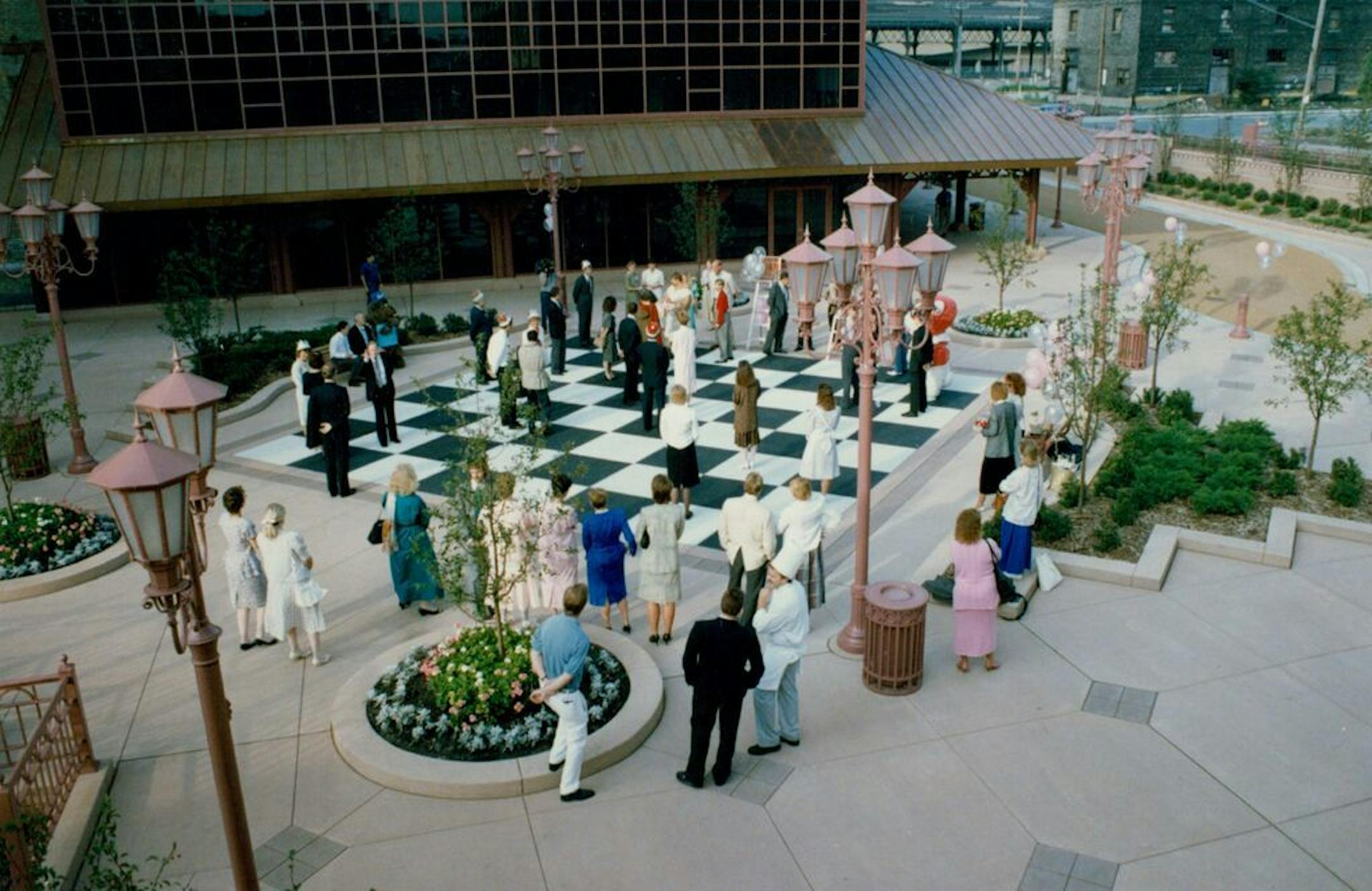 August 1988: A human chess game at the dedication ceremony of the Whitney Mill Quarter, 2nd St. and Portland Av., in Minneapolis. Participating celebrities included Mayor Don Fraser, ex-Viking Bob Lurtsema, Council Member Barbara Carlson and theater magnate Dudley Riggs.