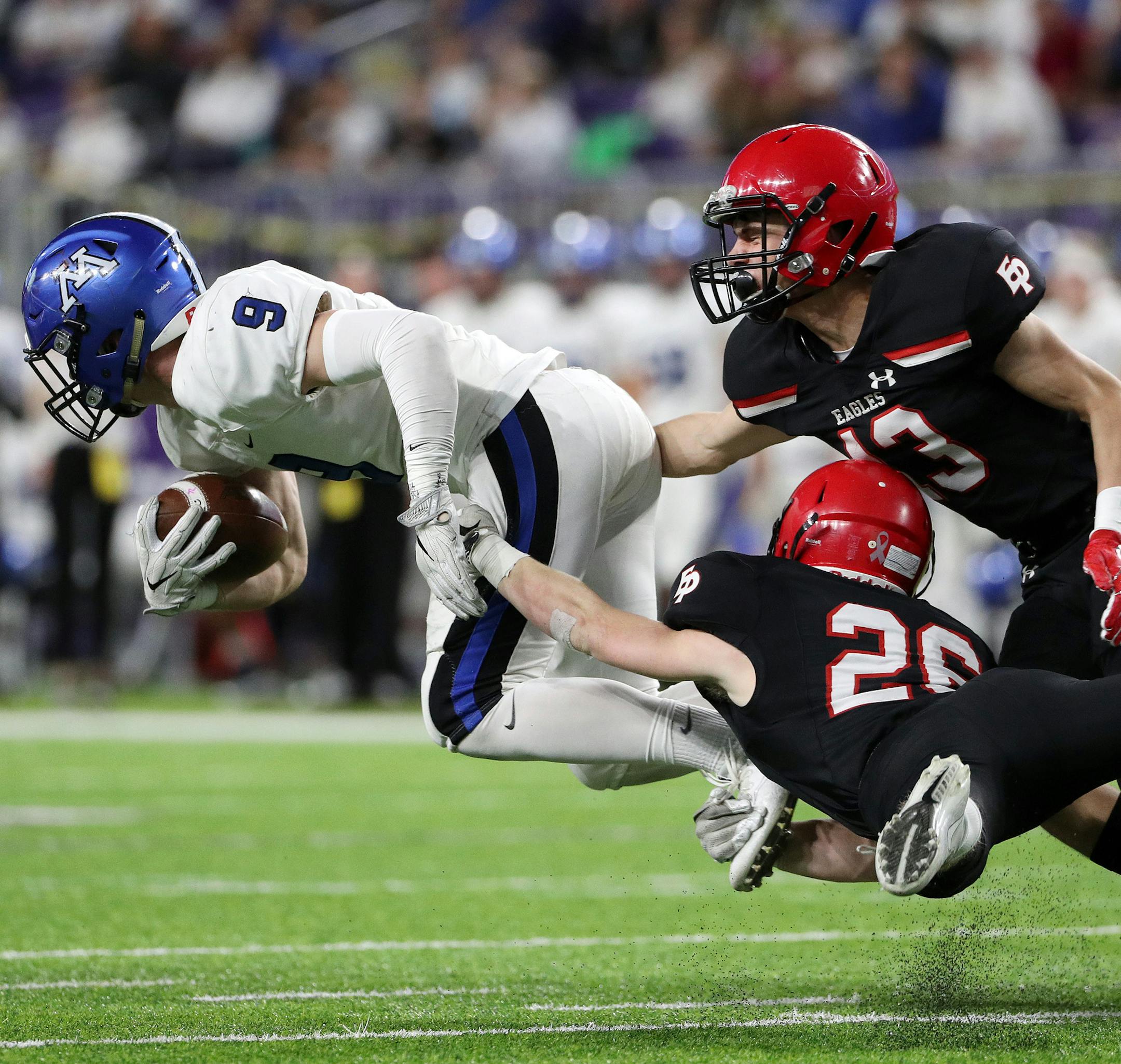 Eden Prairie High School defensive back Grant Harstad (26) and Eden Prairie High School defensive back Aaron Timm (13) tried to stop Minnetonka High School free safety Jack Beil (9) as he ran the ball in the first half. ] ANTHONY SOUFFLE ï anthony.souffle@startribune.com Game action from a Class 6A championship football game between Eden Prairie High School and Minnetonka High School Friday, Nov. 24, 2017 at U.S. Bank Stadium in Minneapolis.