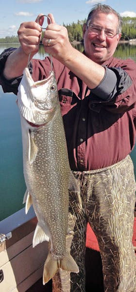 Hennepin County Attorney Mike Freeman relaxing with a luniker lake trout.