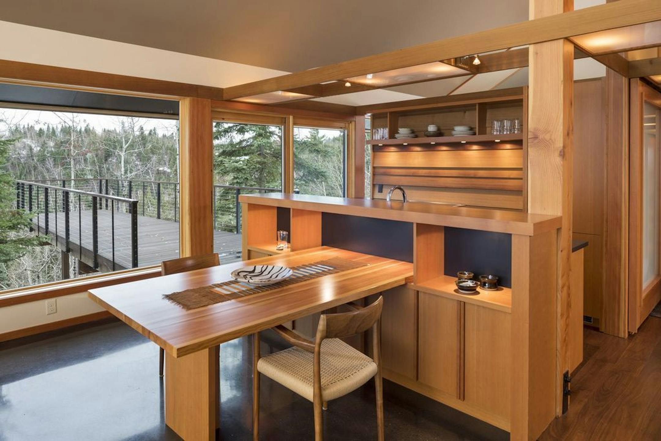 The kitchen features Douglas fir cabinets and a table that slides in and out from the island to create more seating space if needed.