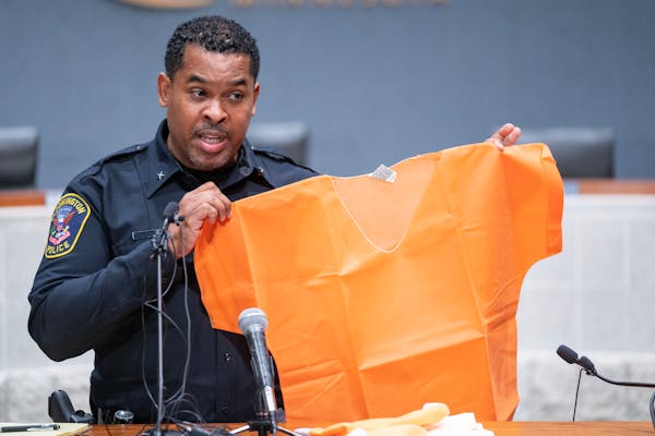 Bloomington Police Chief Booker Hodges held up a prison jumpsuit at a news conference Saturday, Dec. 24, while speaking about the previous day’s sho