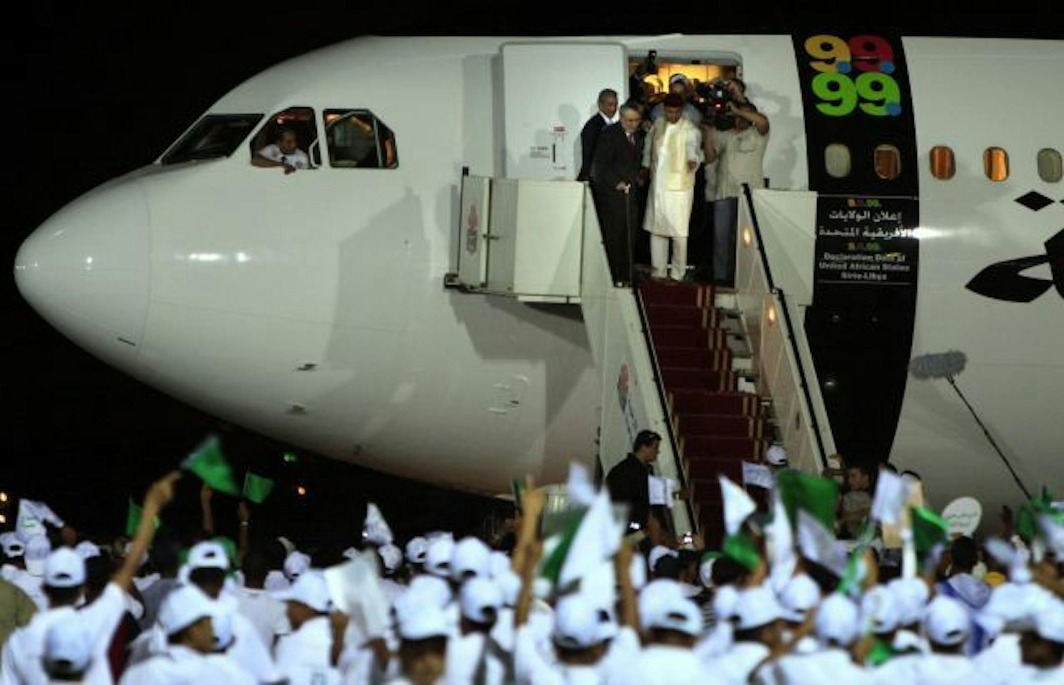 Libyan Abdel Baset al-Megrahi, who found guilty of the 1988 Lockerbie bombing, top left, is accompanied by Seif al-Islam el- Gadhafi, son of Libyan leader Moammar Gadhafi upon his arrival at airport in Tripoli, Libya, Thursday.