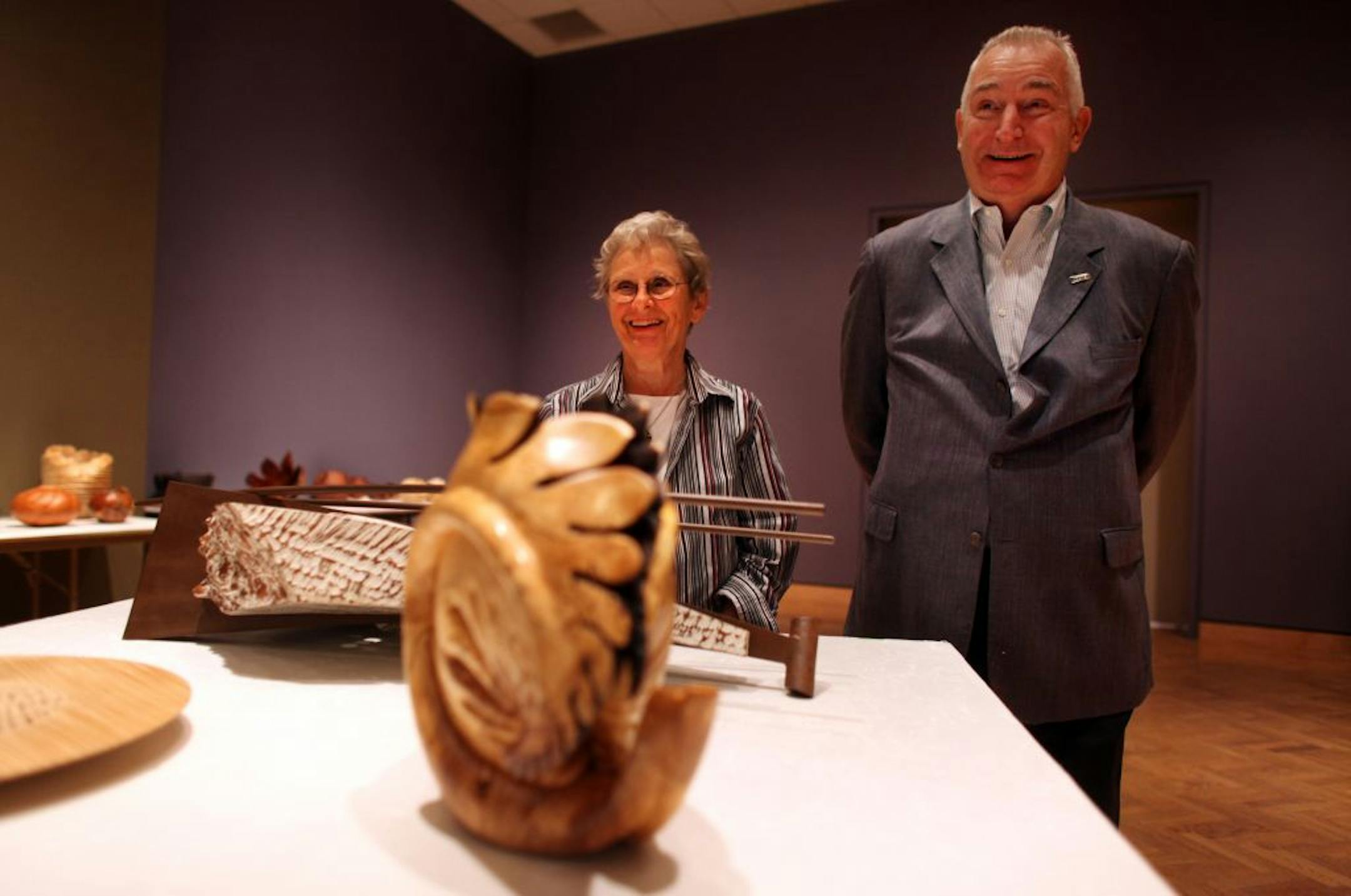 Ruth and David Waterbury with pieces from their collection, including Michelle Holzapfel's "Blossfeldt Vase," foreground.