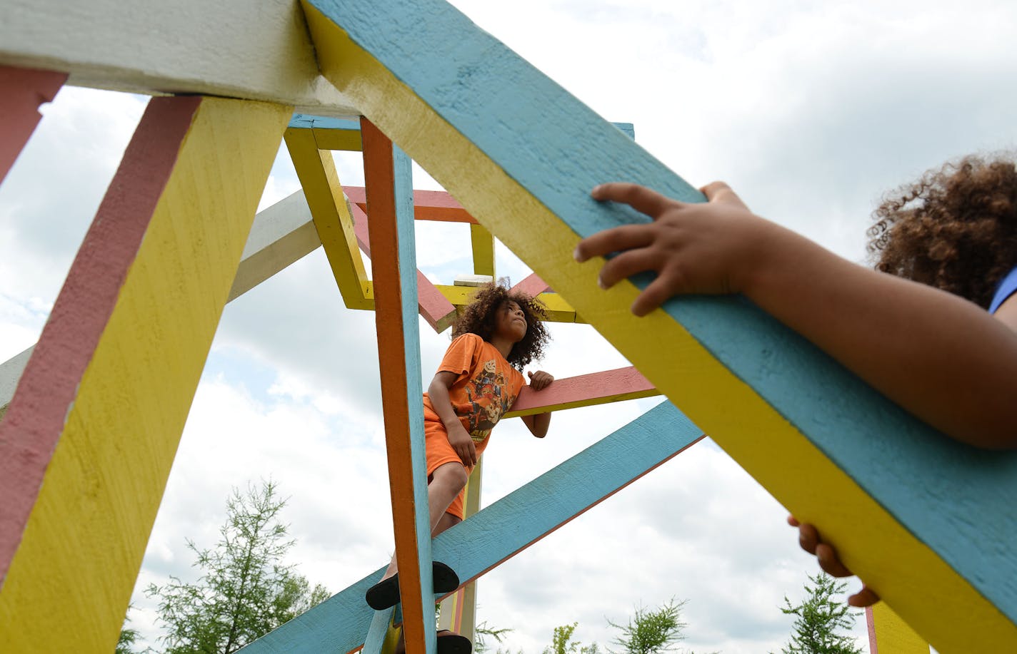 From left, siblings Deahmondre Ivy, 9, and Dyzariah Ivy, 7, both of Iowa, climbed a sculpture in the Franconia Sculpture Park in Shafer in the Chisago Lakes Area, Minn., on Friday June 19, 2015. The Chisago Lakes Area is made up of Chisago City, Lindstrom, Scandia, Center City, Shafer, Taylors Falls and Almelund. ] RACHEL WOOLF &#x2022; rachel.woolf@startribune.com