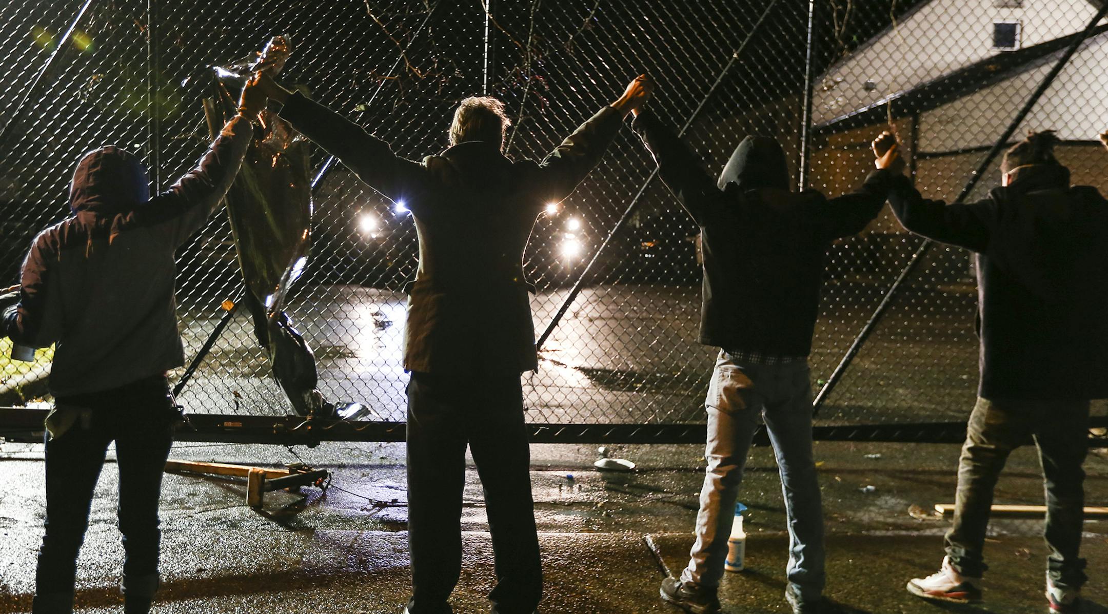 Protesters lined up with their hands in the air at an entrance at the fourth precinct on Wednesday, November 18, 2015, in Minneapolis, Minn. ] RENEE JONES SCHNEIDER • reneejones@startribune.com Black lives matter. Jamar Clark ORG XMIT: MIN1511182310090786