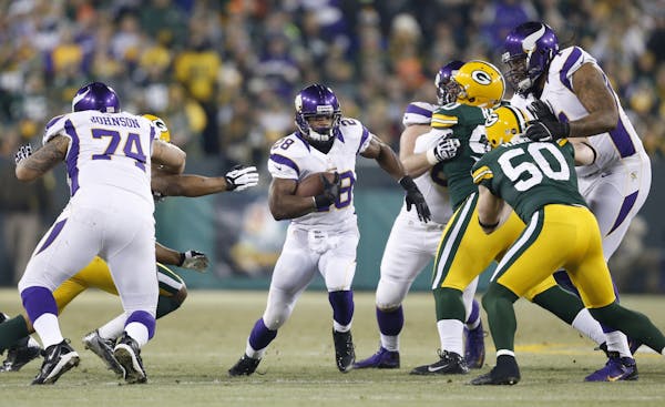 Vikings running back Adrian Peterson ran for a short gain in the first quarter against the Green Bay Packers at Lambeau Field.