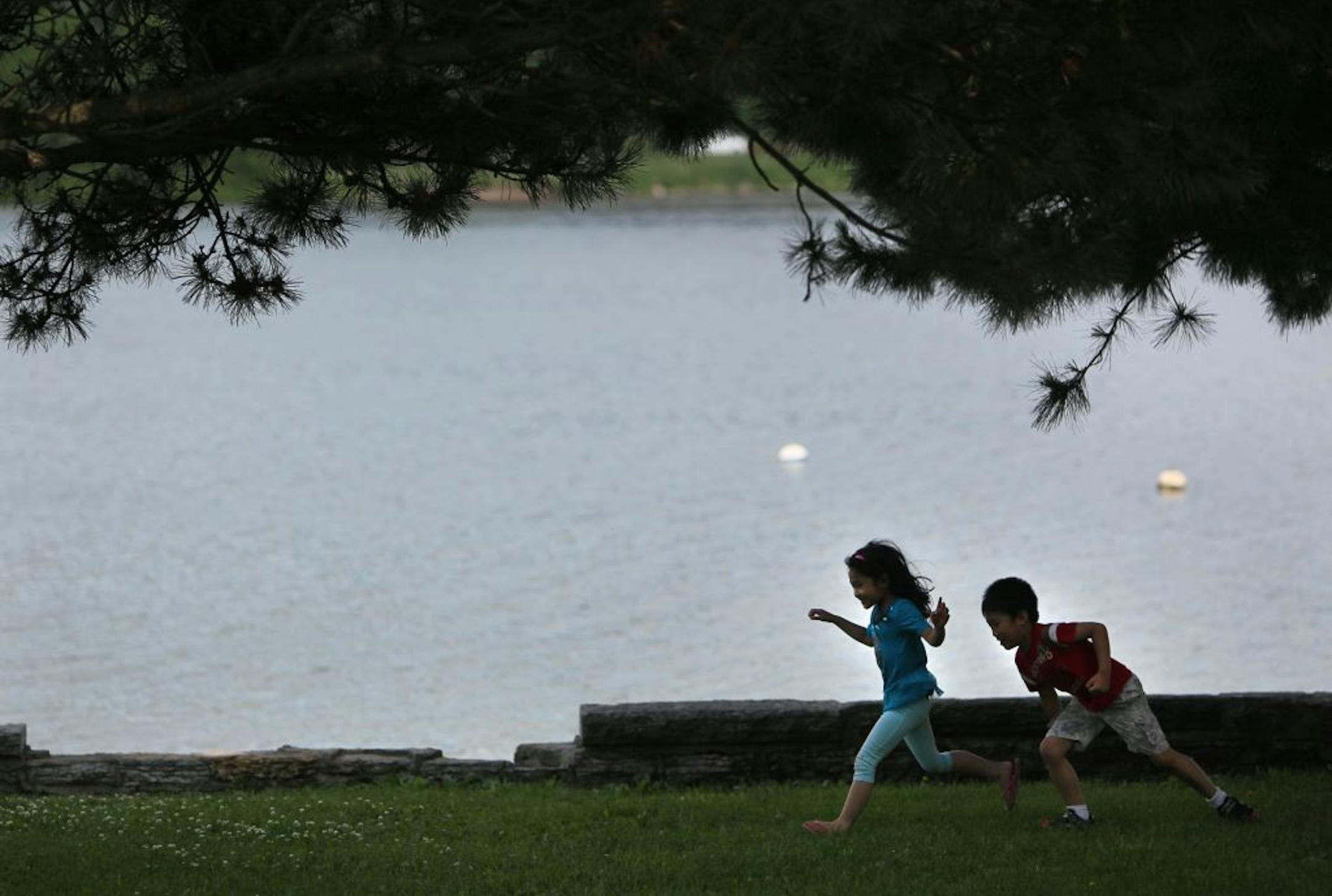 Chukong Thao, 7, and his sister Pada Thao, 5, raced along the shores of Lake Phalen during a family outing.