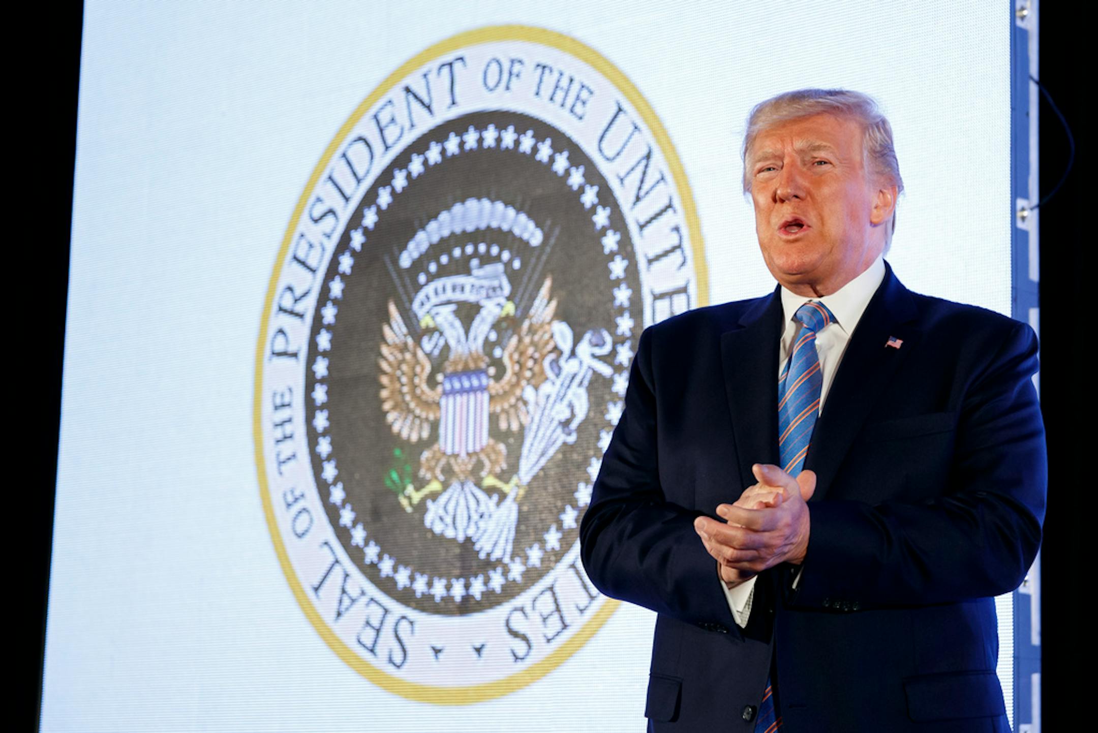 President Donald Trump arrives to speak, with an altered presidential seal behind him, at Turning Point USA's Teen Student Action Summit 2019, Tuesday, July 23, 2019, in Washington.