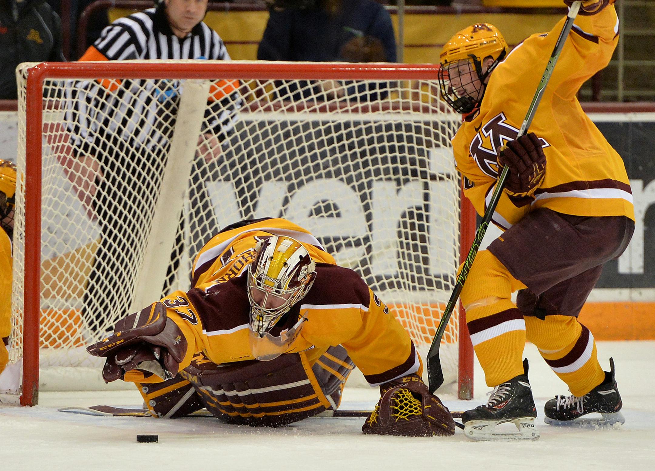 Minnesota goaltender Eric Schierhorn dives to save a Michigan shot on net during the second period of the second game in the home series Friday, Feb. 26 at Mariucci Arena. ] (SPECIAL TO THE STAR TRIBUNE/BRE McGEE) **Eric Shierhorn (MN goaltender)